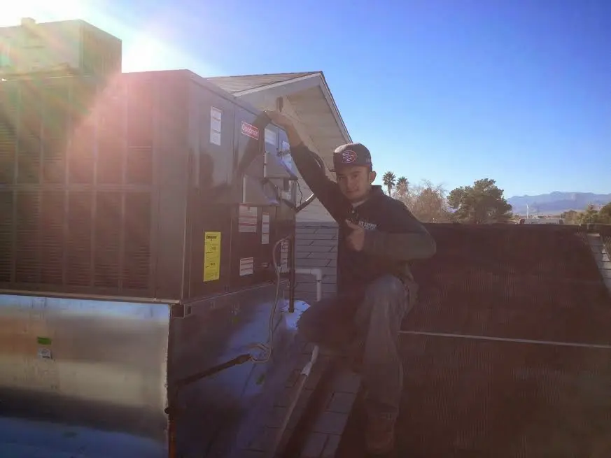 HVAC technician performing HVAC Inspection on a rooftop unit in Germantown
